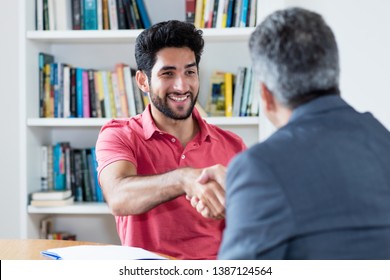 Handshake Of Latin American Male Apprentice After Job Interview With Businessman At Office