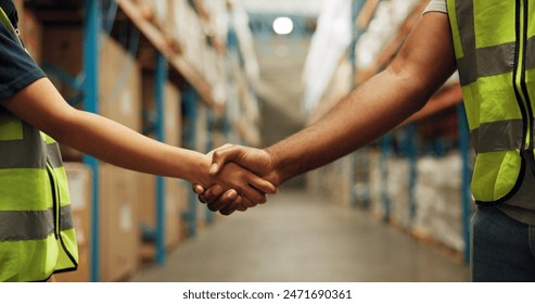 Handshake, logistics and closeup of people in warehouse with deal, partnership and ecommerce teamwork. Collaboration, greeting and zoom of employees shaking hands for onboarding welcome in factory. - Powered by Shutterstock