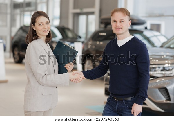 handshake, a man\
buys a car dealership and signs a contract. A successful man\
chooses a new car. Service center for rental or repair of vehicles.\
trade in loan secured by a\
automobile