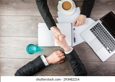 Handshake - Man and woman Hand holding. Top view for top managers - Powered by Shutterstock