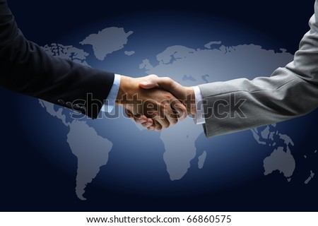 Handshake with map of the world in background