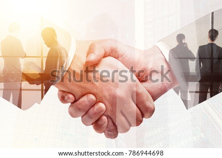 Handshake on abstract city background. Teamwork and meeting concept. Double exposure 