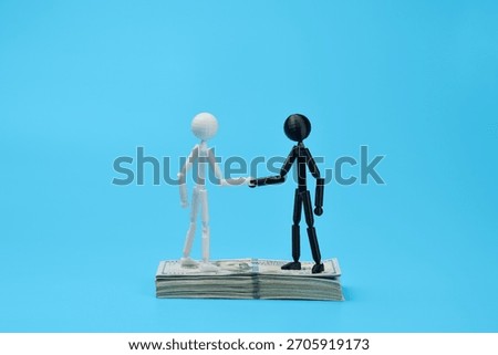 Handshake on dollar stack symbolizes joint financial prosperity and success.