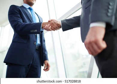Handshake of partners - Shutterstock ID 517028818