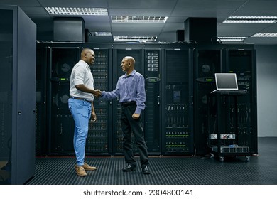 Handshake, partnership or men in server room of data center worker with a thank you hand shake for help. B2b deal agreement, shaking hands or people in collaboration for network glitch or IT support