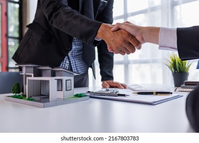 Handshake Real estate broker agent presenting and consult to customer to decision making sign insurance form agreement, buy and sell home model, concerning mortgage loan offer for and house insurance - Shutterstock ID 2167803783
