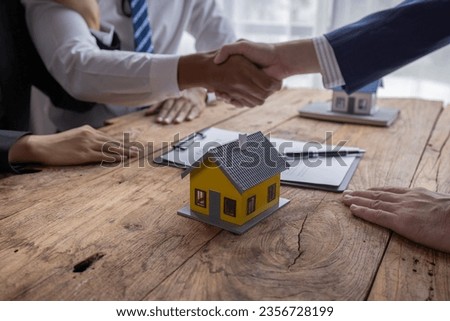 Handshake Real estate brokerage agent Deliver a sample of a model house to the customer, mortgage loan agreement Making lease and buy and sell house And contract home insurance mortgage loan concept	