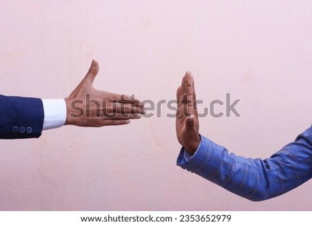 Handshake refuses. The man is refusing to shake hand with businessman.