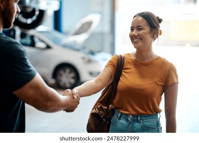 Handshake, smile and woman with mechanic in workshop for deal on vehicle repair or maintenance. Happy, agreement and Asian female person shaking hands with industrial worker in garage for car service - Powered by Shutterstock