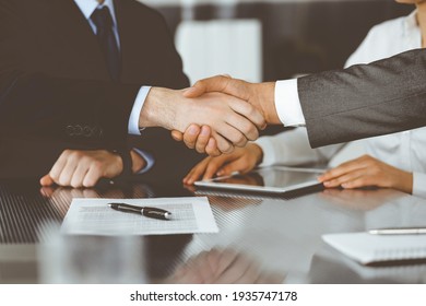 Handshake as successful negotiation ending, close-up. Unknown business people shaking hands after contract signing in modern office - Shutterstock ID 1935747178