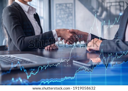 A handshake as a symbol of successful transaction on brokerage services at international investment bank. Capital market, stock trading. Financial hologram chart. Women in business.