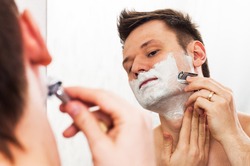 Handsome 30 Years Old Man Shaves In Front Of The Mirror With Adjustable Double Edged Safety Razor 