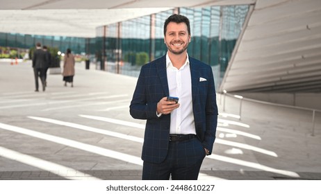 Handsome 30s top manager portrait in formal suit. Successful entrepreneur look camera. Confident business man smile. Young male businessman face. Urban city background. 40s employee work. Office boss. - Powered by Shutterstock