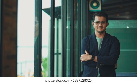 Handsome 38 years old gentle asian  man, wearing glasses, formal slick hairstyle,  in a modern office building beside a huge window