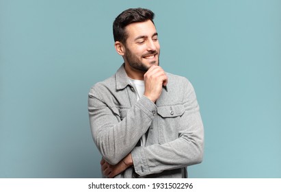 Handsome Adult Blond Man Smiling With A Happy, Confident Expression With Hand On Chin, Wondering And Looking To The Side