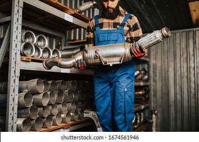 Handsome Adult Man Working In Car And Truck Spare Parts Warehouse. 