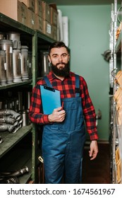 Handsome Adult Man Working In Car And Truck Spare Parts Warehouse. 