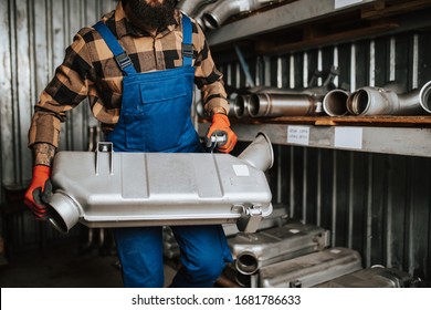 Handsome Adult Man Working In Car And Truck Spare Parts Warehouse. 