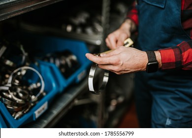 Handsome Adult Man Working In Car And Truck Spare Parts Warehouse. 