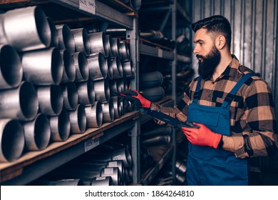 Handsome Adult Man Working In Car And Truck Spare Parts Warehouse. 