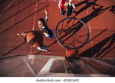 Handsome African American Basketball Player Posing With A Ball.