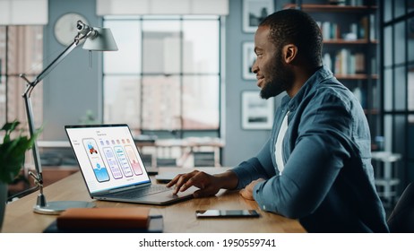 Handsome African American Designer Working on Desktop Computer in Creative Living Room. Freelance Male is Developing New Food Delivery App Design, User interface in a Digital Graphics Editing Software