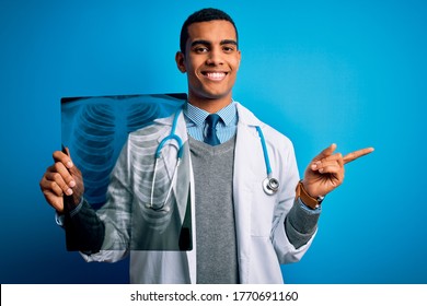 Handsome African American Doctor Man Wearing Stethoscope Holding Chest Xray Very Happy Pointing With Hand And Finger To The Side