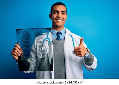 Handsome African American Doctor Man Wearing Stethoscope Holding Chest Xray Happy With Big Smile Doing Ok Sign, Thumb Up With Fingers, Excellent Sign