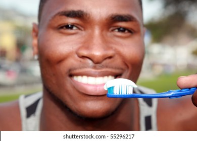 a handsome african american male is excited about brushing his teeth - Powered by Shutterstock