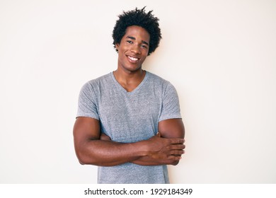 Handsome african american man with afro hair wearing casual clothes happy face smiling with crossed arms looking at the camera. positive person.  - Shutterstock ID 1929184349