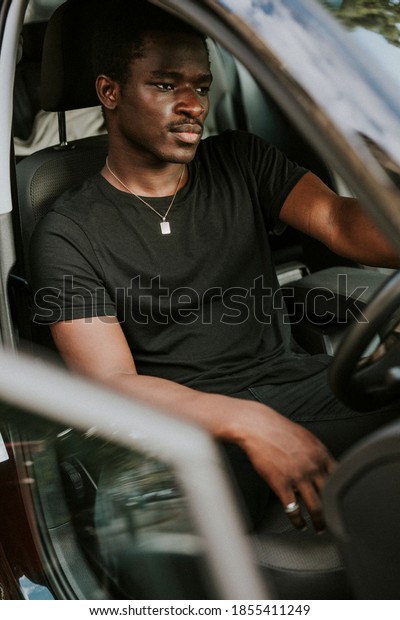 Handsome African\
American man driving a\
car