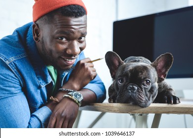 Handsome African American Man With Frenchie Dog By Computer Screen