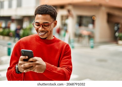 Handsome african american man outdoors using smartphone typing a message - Powered by Shutterstock