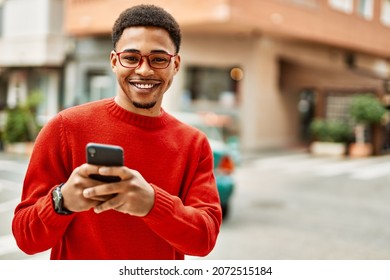 Handsome african american man outdoors using smartphone typing a message - Powered by Shutterstock