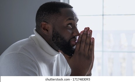 Handsome african american man thanking God for help and support, religion
