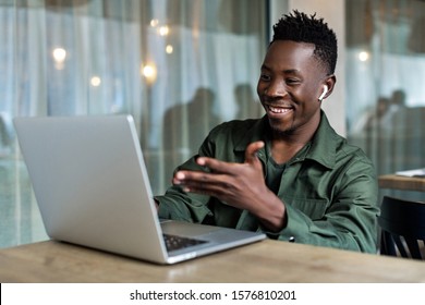 Handsome African American Man Using Computer And Smiling. Online Video Chat With Friends. Home Work