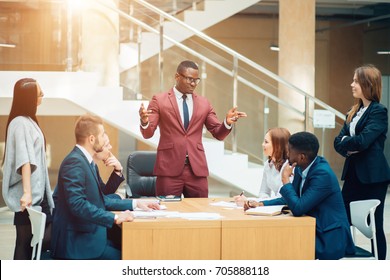 handsome african businessman with group of businesspeople