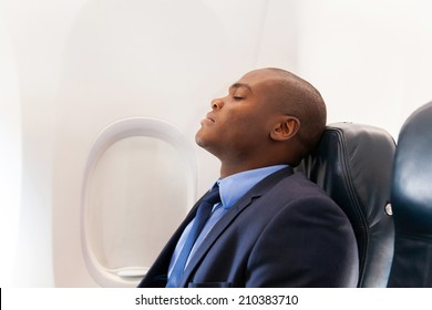 Handsome African Businessman Resting On Airplane