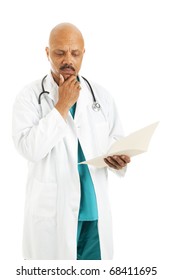 Handsome African-american Doctor Reviewing A Patient's Medical Chart.  Isolated On White.