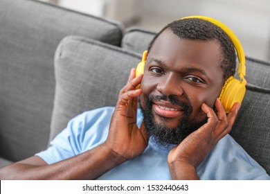 Handsome African-American man listening to music at home - Shutterstock ID 1532440643
