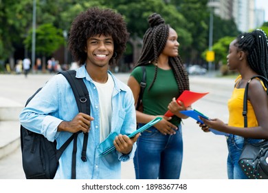 Handsome Afro American Male Student With Group Of Young Adults Outdoor In City In Summer