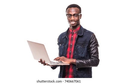 Handsome Afro American man is using a laptop, looking at camera and smiling, against white - Shutterstock ID 740667061