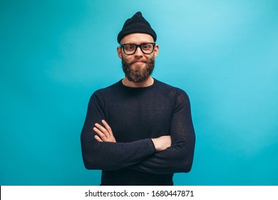 Handsome American Hipster Guy With Beard Wearing Casual Beanie And Black Longsleeve Shirt With Space For Your Logo Or Design. Mockup For Print