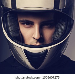 Handsome Angry Man In Motorcyclist Helmet On Dark Studio Background. Closeup Portrait