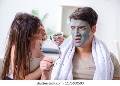 Handsome applying clay mask on face - Shutterstock ID 1175600503