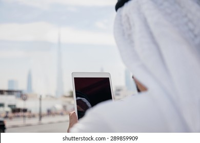 Handsome Arabian Businessman Using Digital Tablet Outdoors.