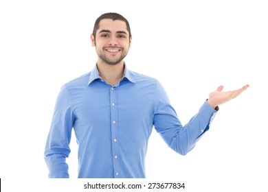 handsome arabic business man in blue shirt pointing at something isolated on white background