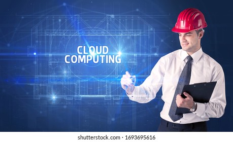 Handsome architect with helmet drawing CLOUD COMPUTING inscription, new technology concept