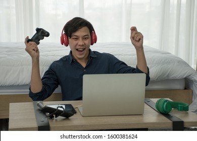 Handsome Asia Boy Recording Video Using Camera At Home Playing Game And Laptop By Joy Stick And Enjoy For Creating Content Game Online