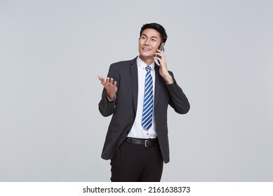 handsome Asian businessman talking mobile phone isolated on studio white background.
 - Powered by Shutterstock